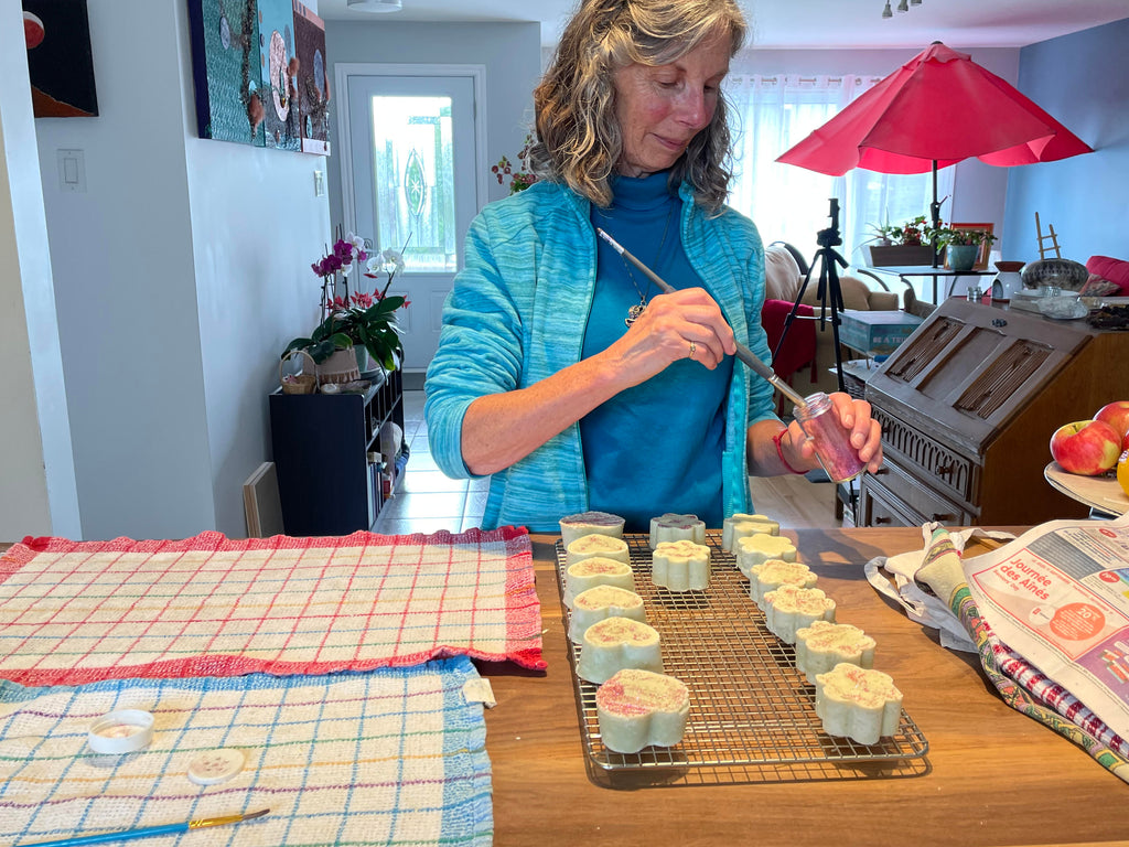 Workshop participant decorating handmade soap bars during a Face to Grace soap making workshop